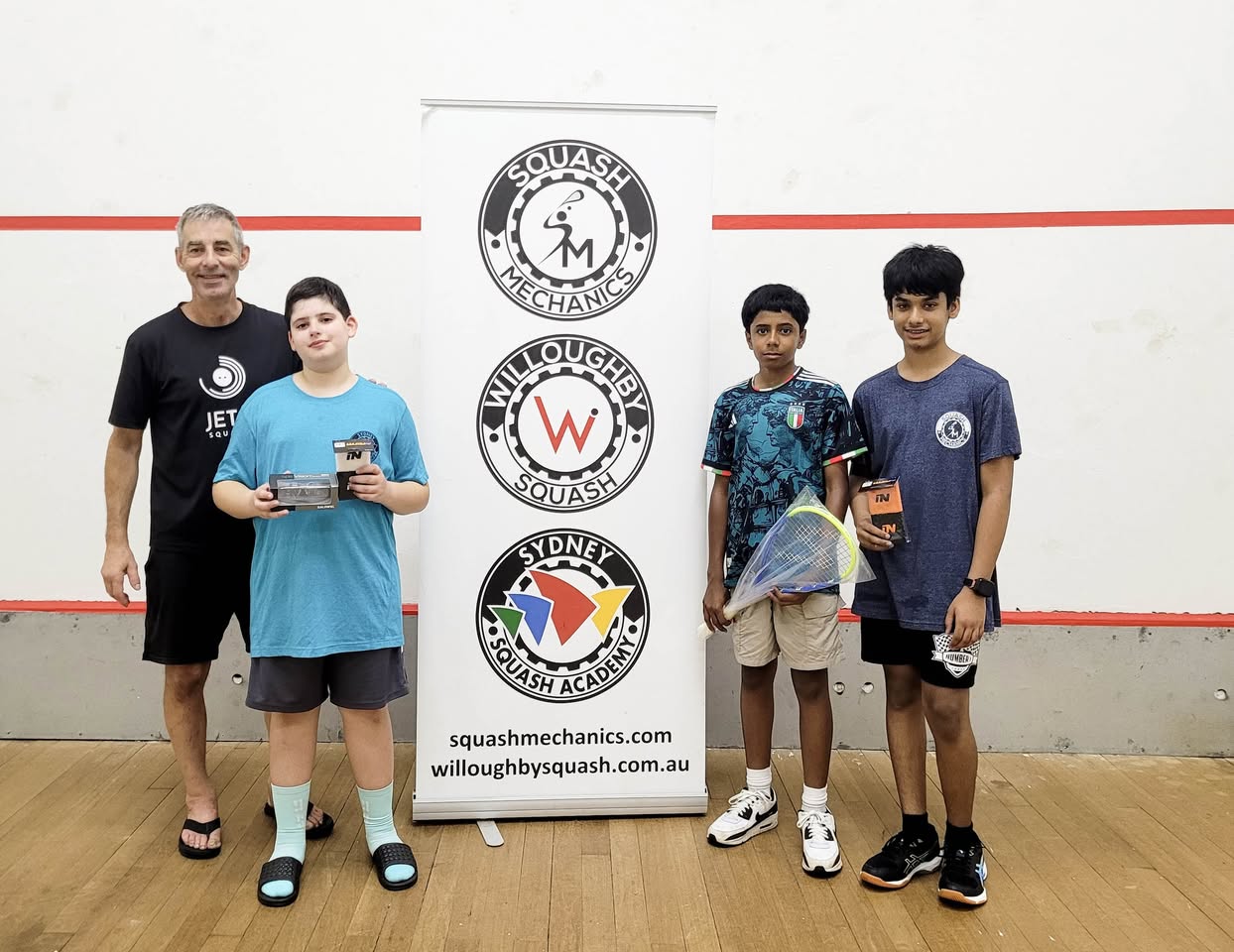 Coach with junior players at competition